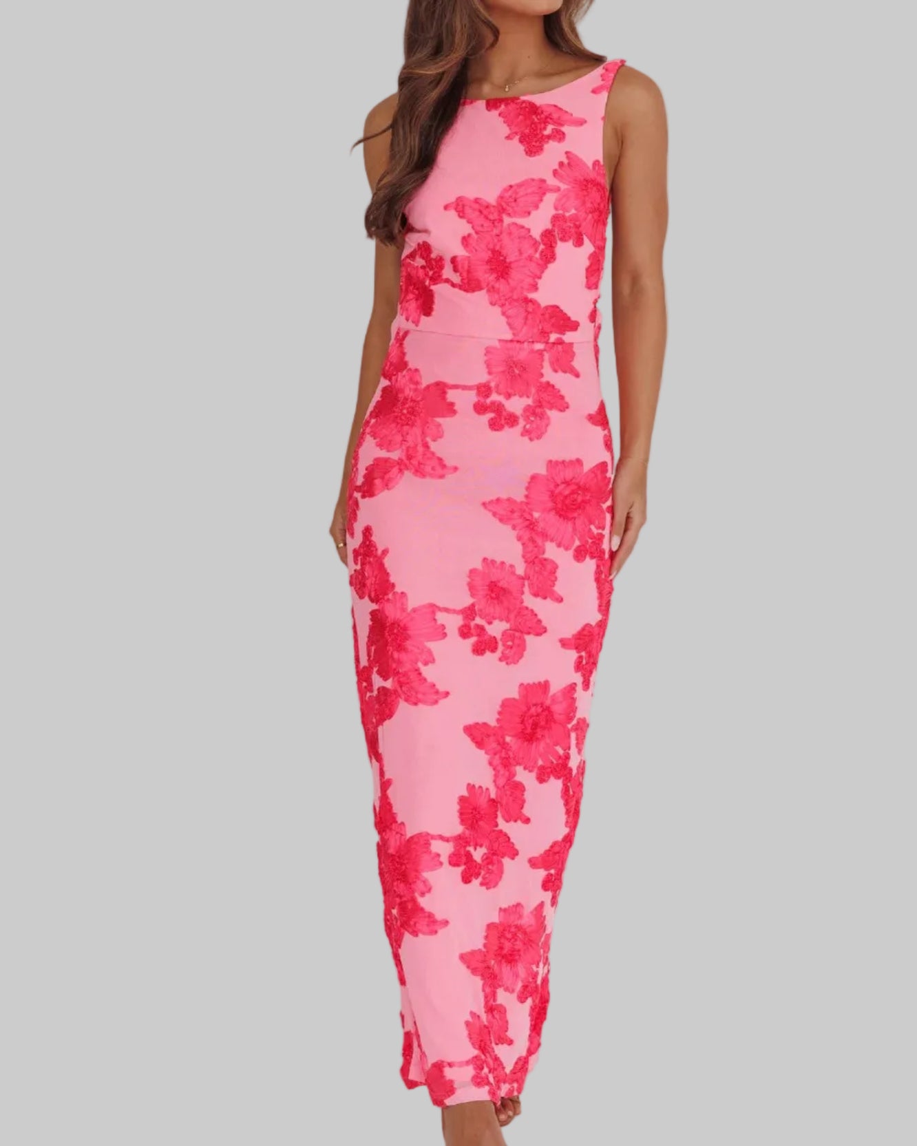 Woman wearing a pink floral dress on a white background