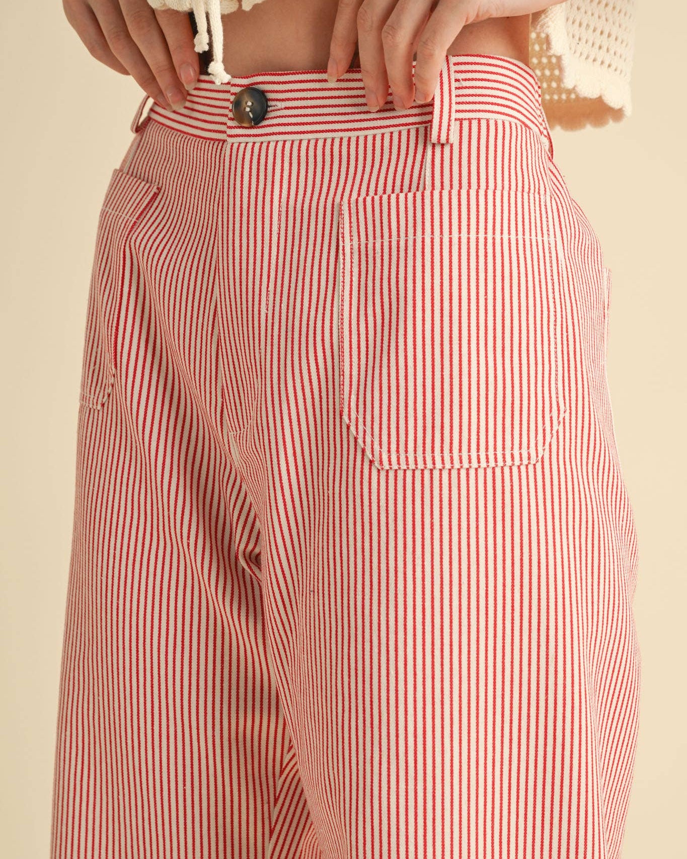 High waist cropped pants with red pinstripe.  Close up view