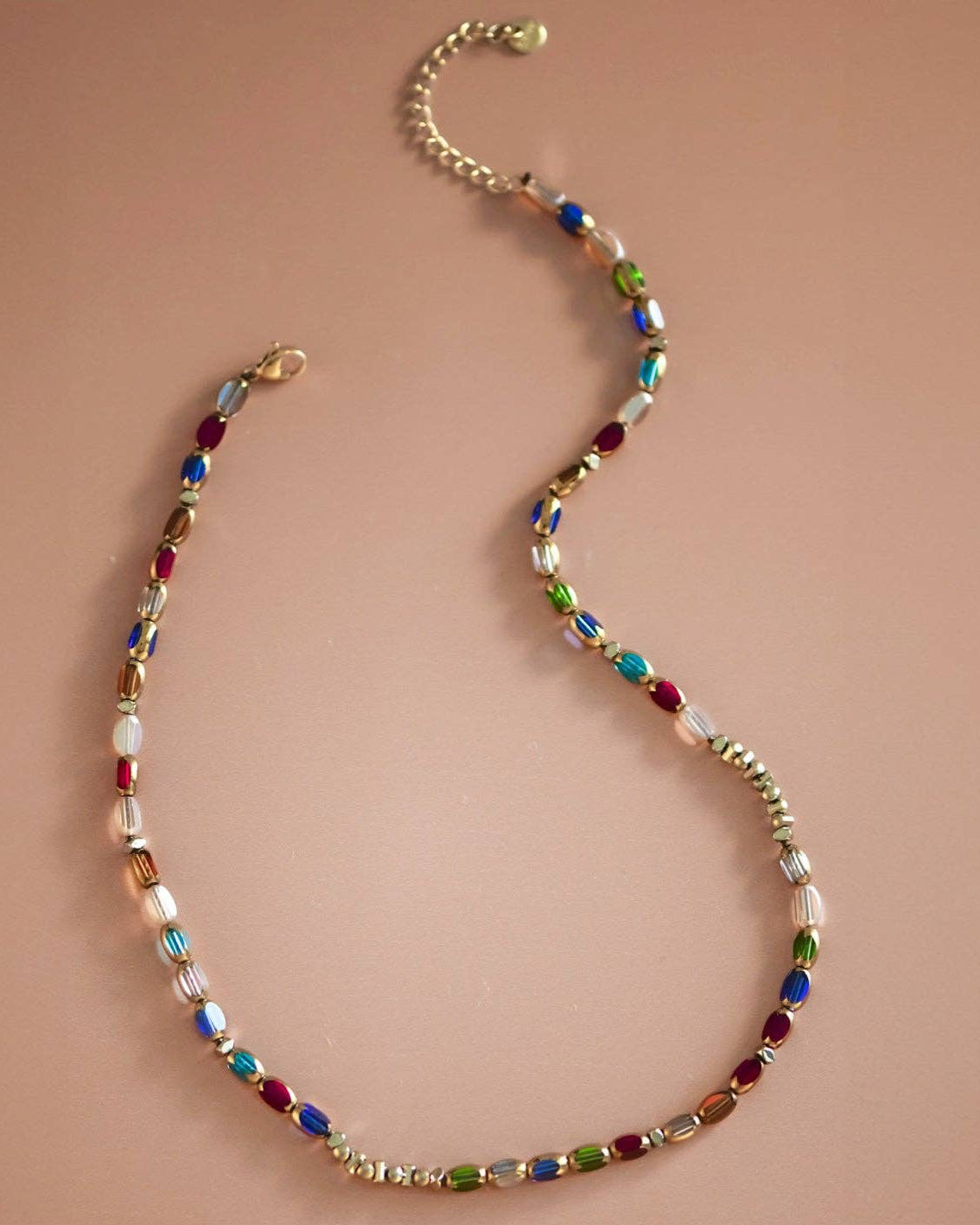 Multicolored beaded necklace on a beige background