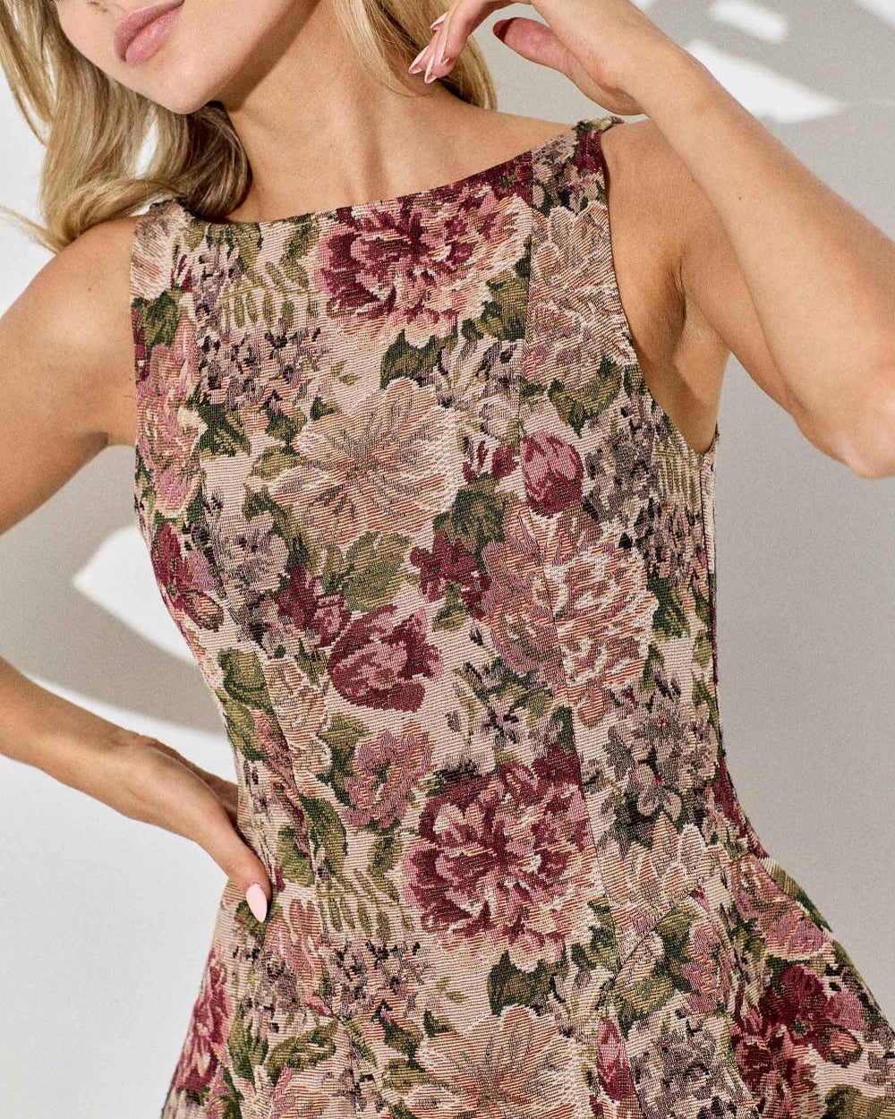 Woman wearing a floral dress with a neutral background
