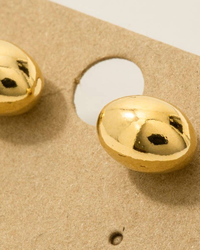 Gold spherical objects on a textured beige surface