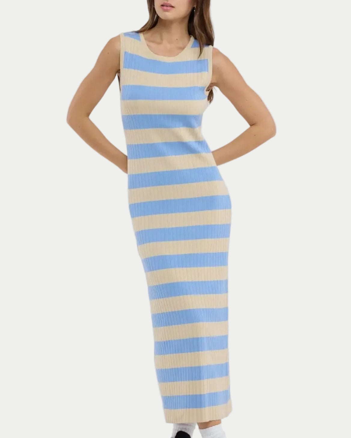 Woman wearing a sleeveless, long, striped dress with blue and beige horizontal stripes on a white background.
