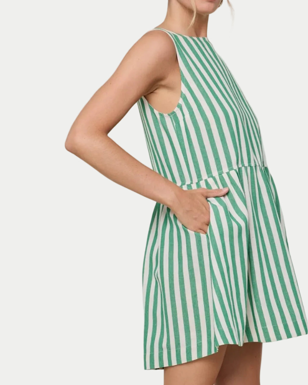 STRIPED MINI DRESS on a model side view with a white background