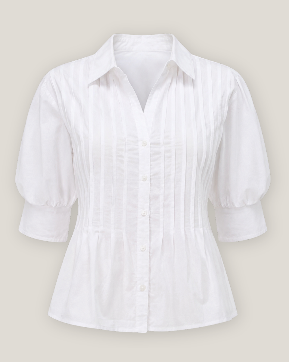 A white short-sleeve button-up blouse with vertical pleats on the front and a pointed collar, shown against a light beige background.