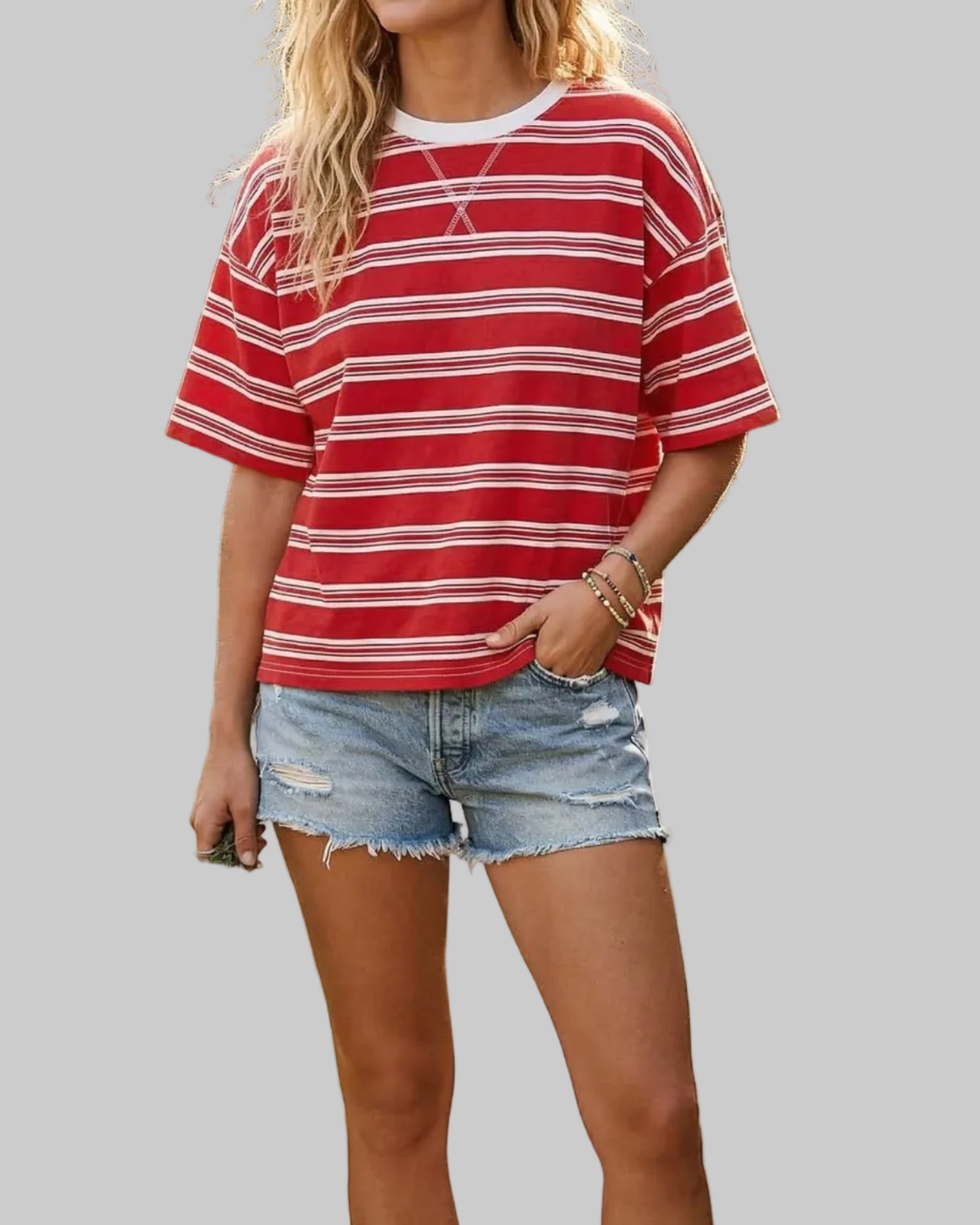 Model wearing a red and white striped shirt on a neutral background