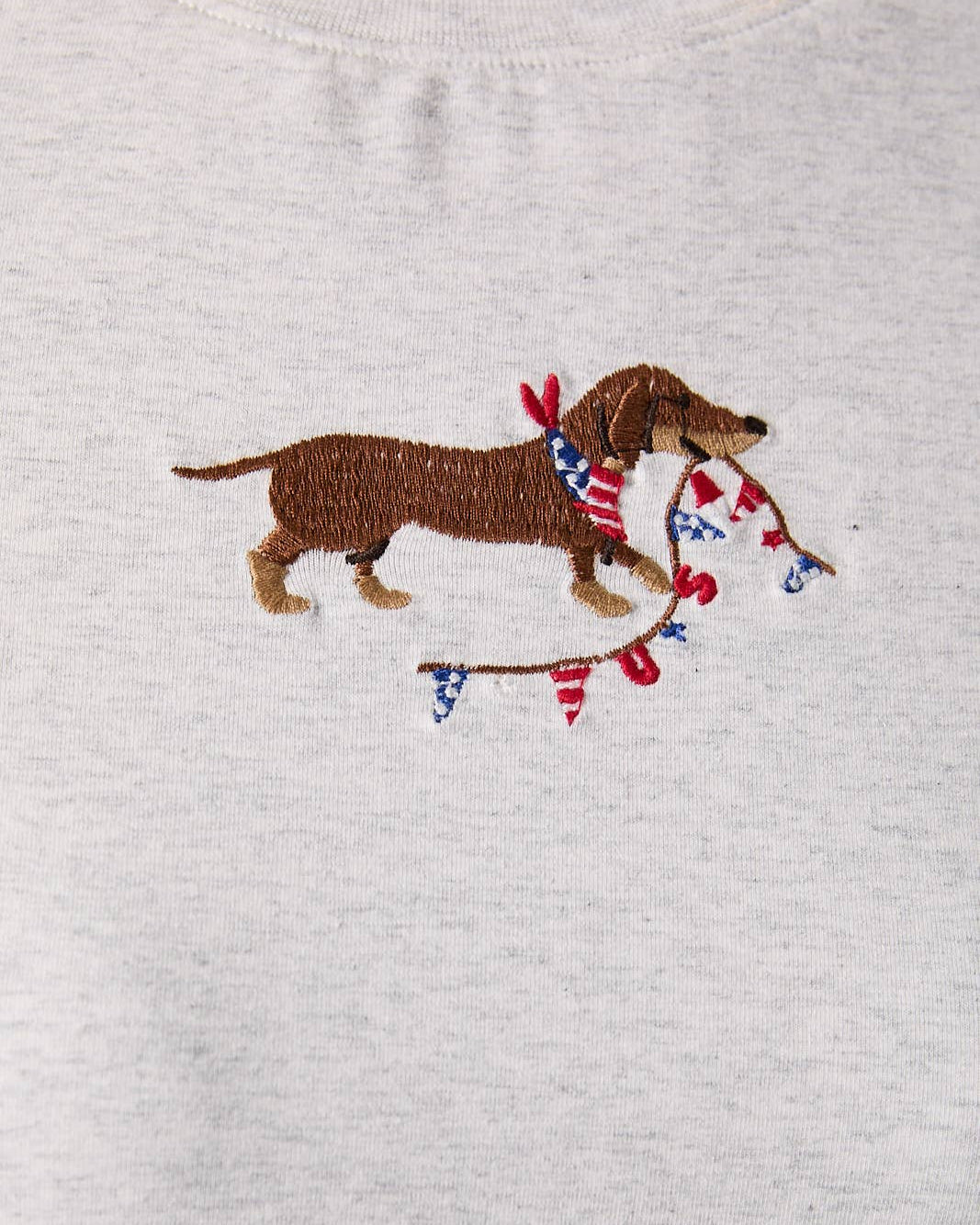 Embroidered dachshund with American flags on a heather gray t-shirt