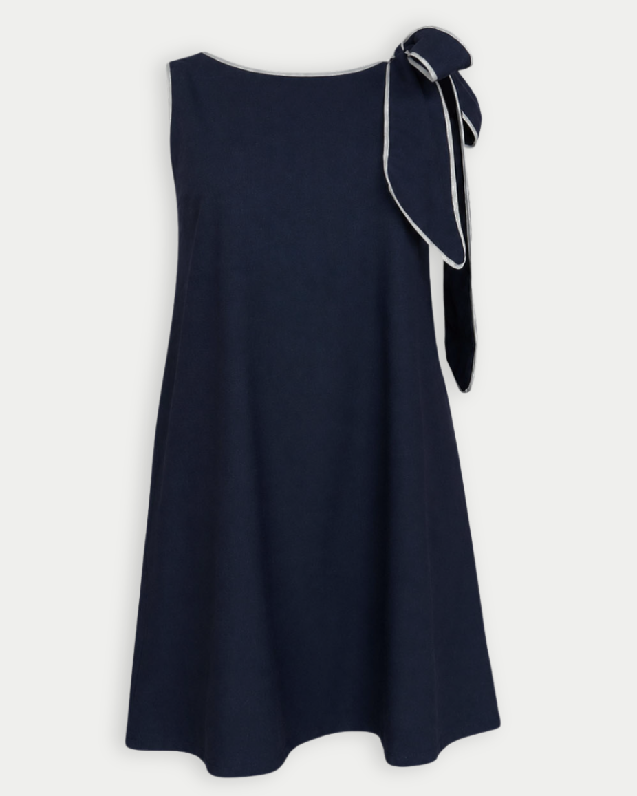 Navy blue dress with a bow detail at the shoulder on a white background