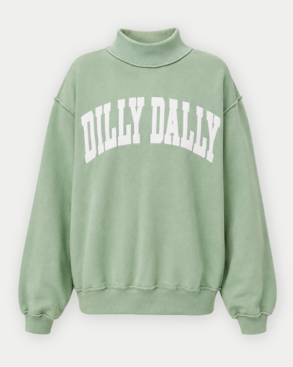 A sage green mock neck sweatshirt with 'DILLY DILLY' printed in white arched block letters across the chest, displayed on a clean light gray background.