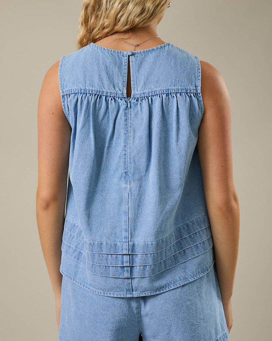 Denim Darling Swing Tank Top on a model with a neutra background- Blackbird Boutique back view