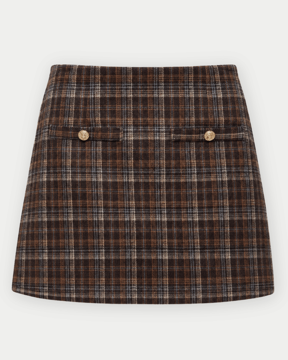 A brown and beige plaid mini skirt with two buttoned flap pockets on the front, shown flat against a light gray background.
