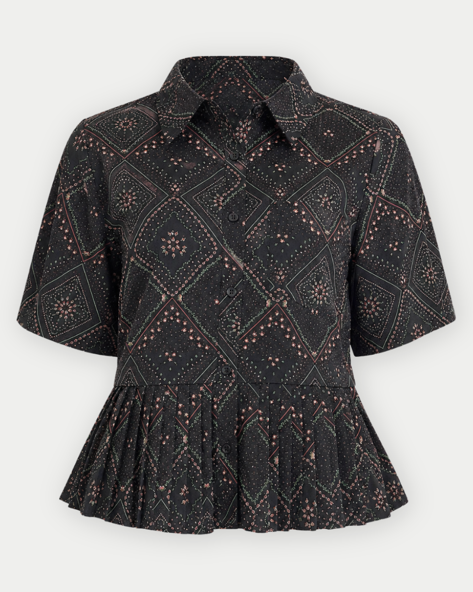 A short-sleeve collared button-front blouse with a geometric bandana print in black and dusty rose, featuring a peplum waist seam.