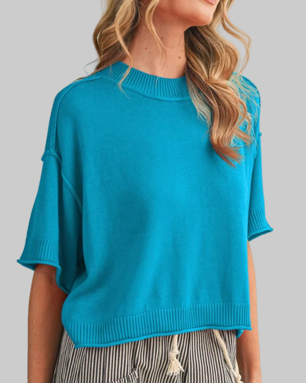 LIGHTWEIGHT KNIT MOCK NECK SHORT SLEEVE SWEATER on a model in true blue.