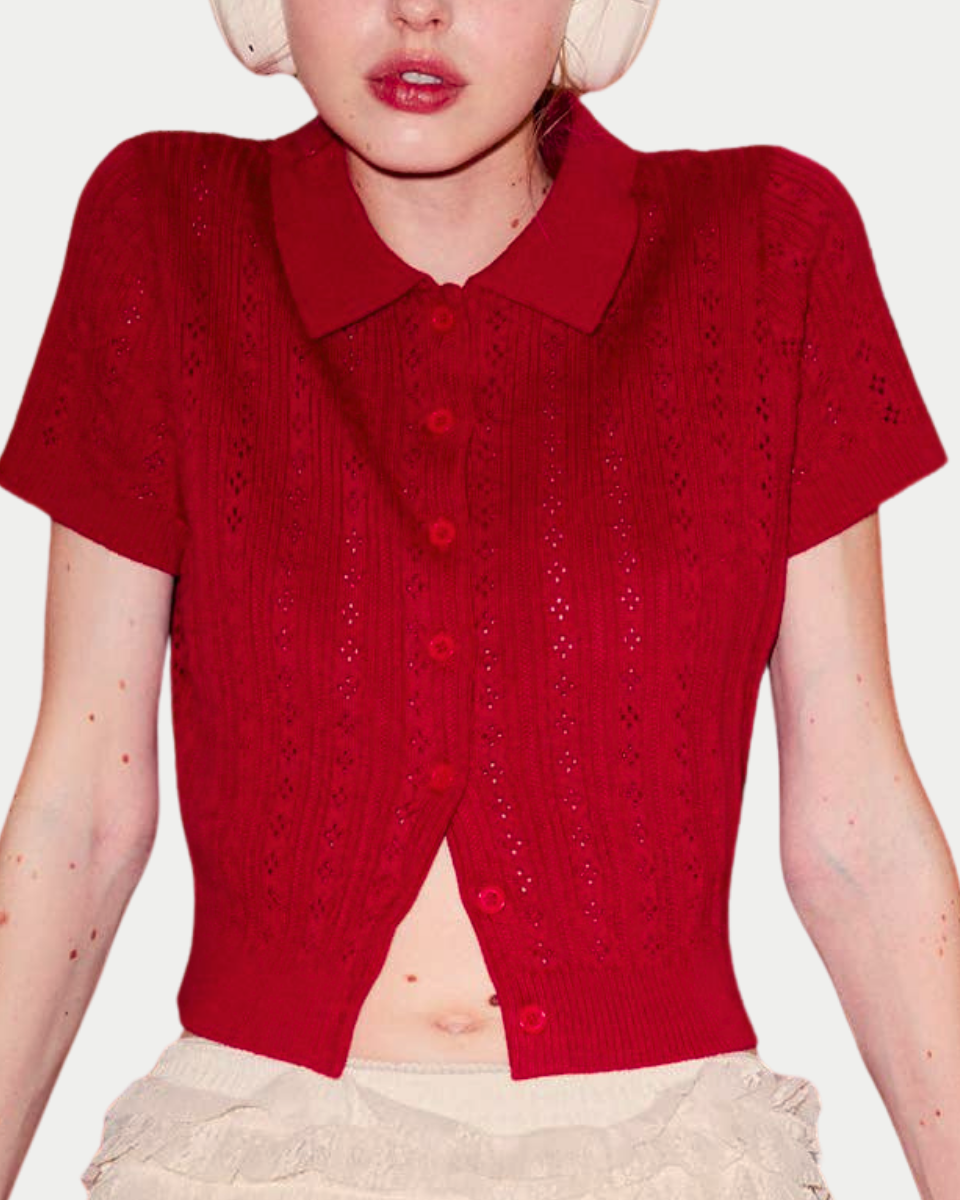 Red knitted cardigan worn by a person on a white background