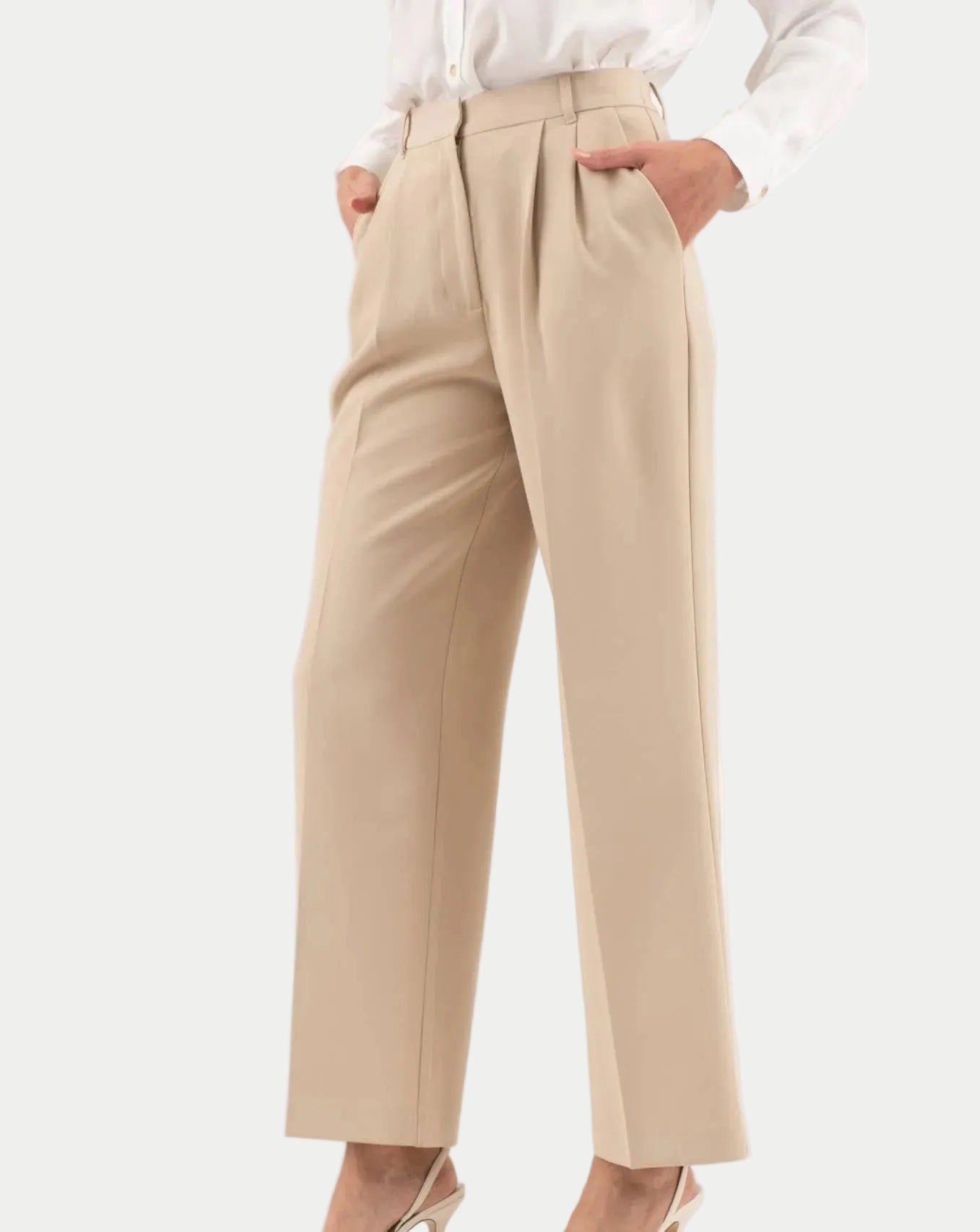Beige pants worn by a person on a white background