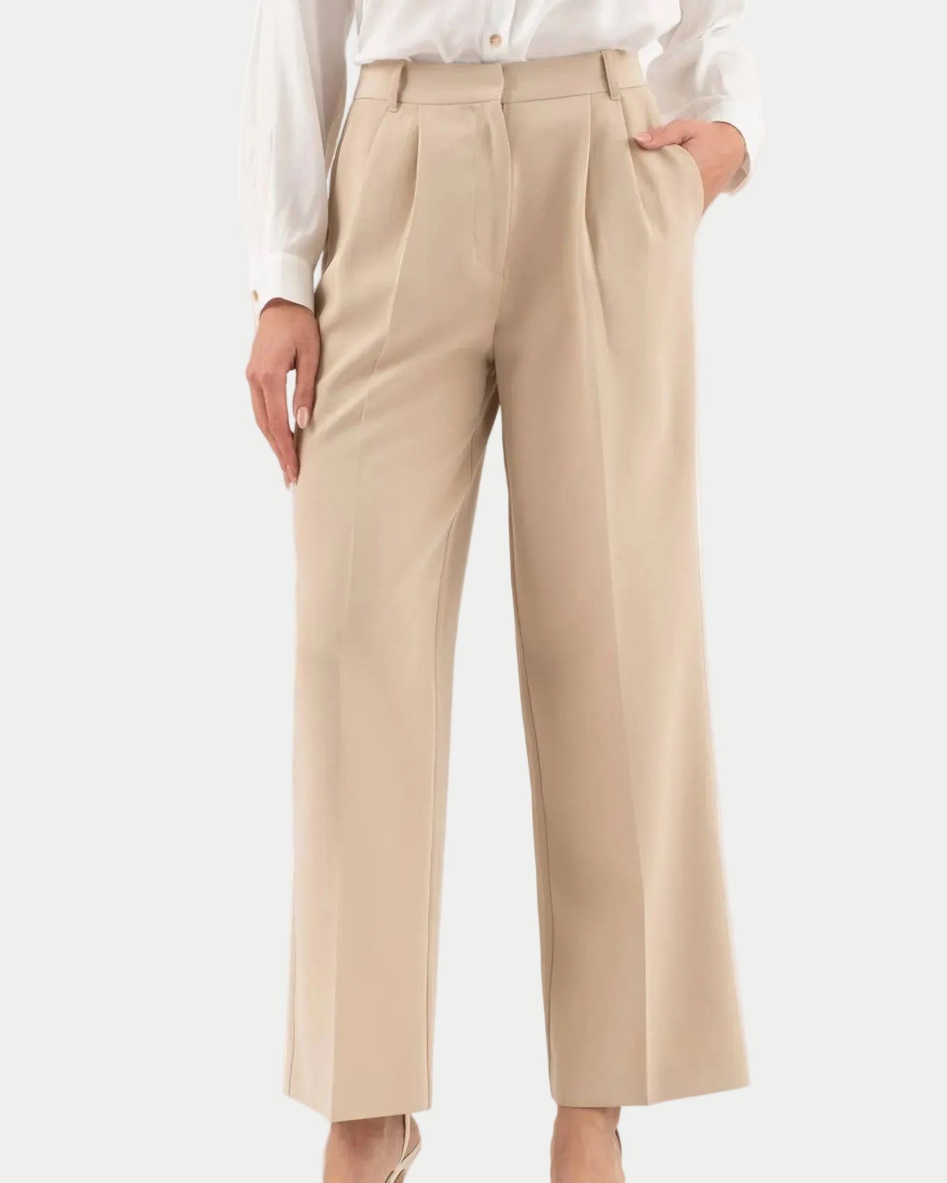 Beige pants worn with a white shirt on a white background