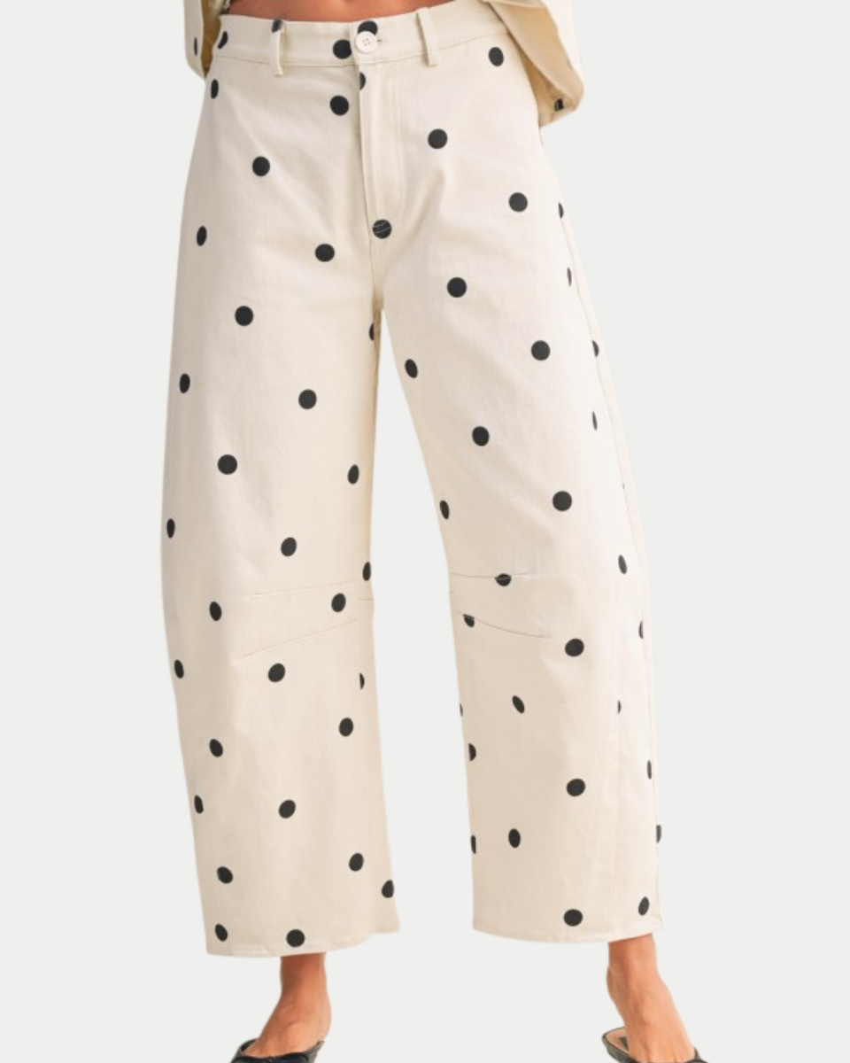 Beige pants with black polka dots on a white background