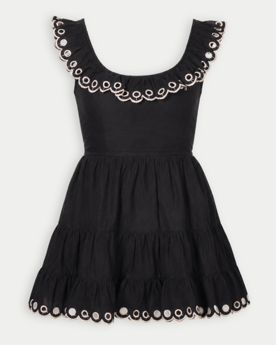 Black dress with decorative trim on a white background