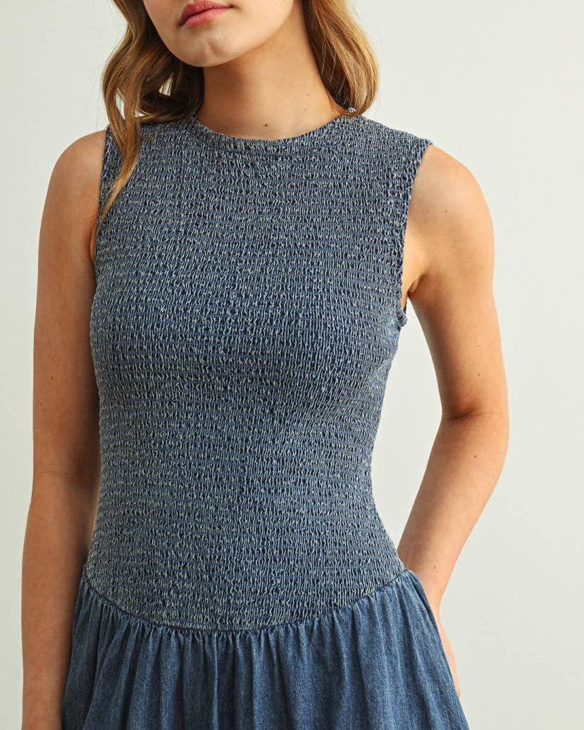 Woman wearing a blue dress against a plain background