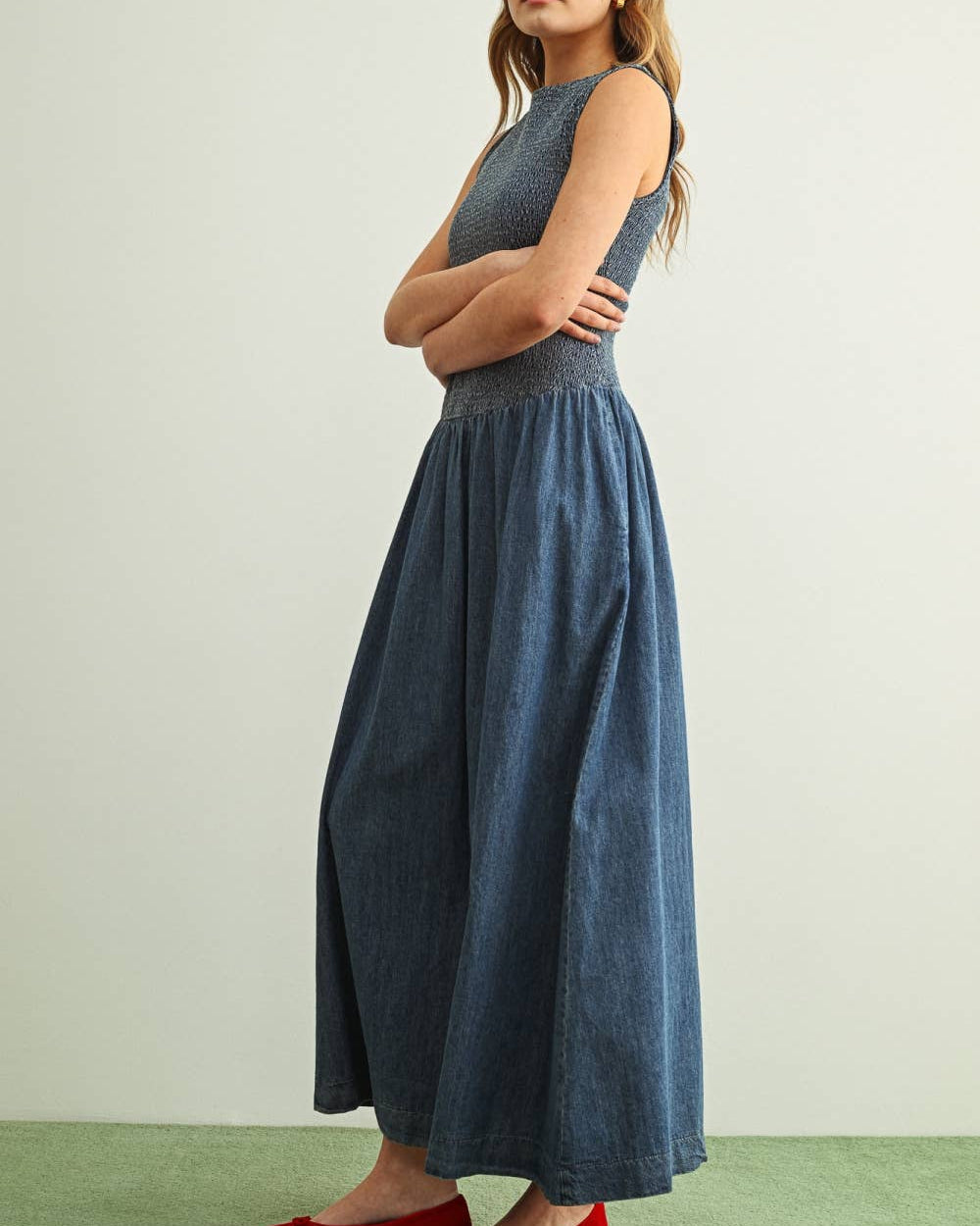 Woman wearing a blue dress with a plain background