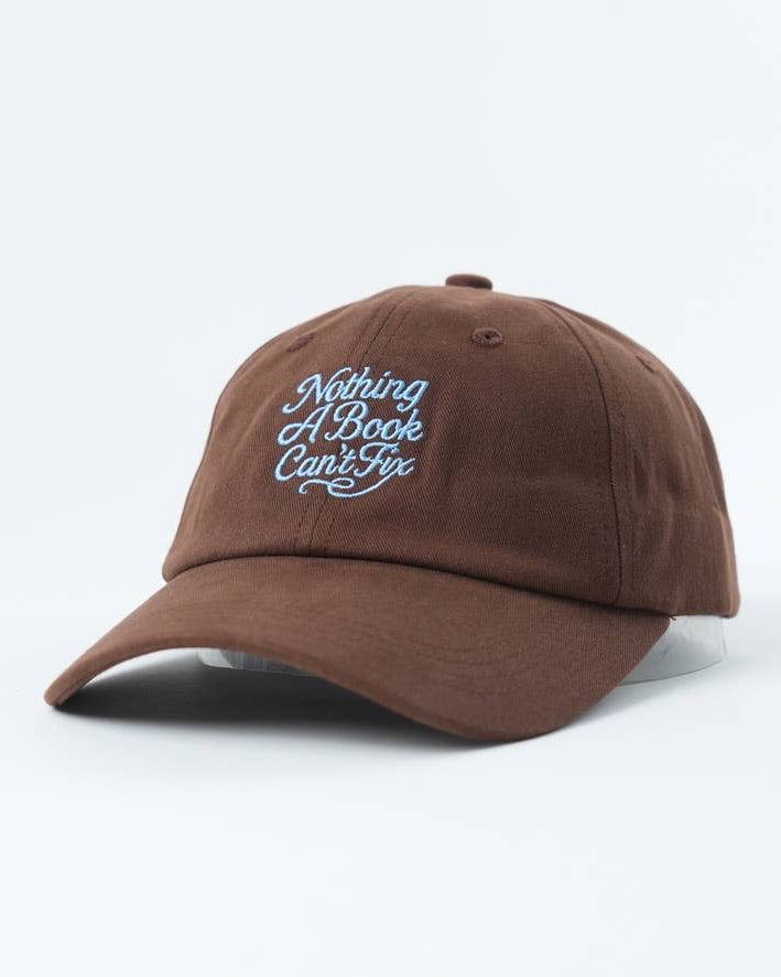 Brown cap with blue text 'Nothing A Book Can't Fix' on a white background