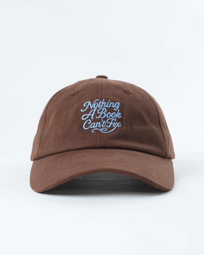 Brown cap with blue text 'Nothing A Book Can't Fix' on a white background
