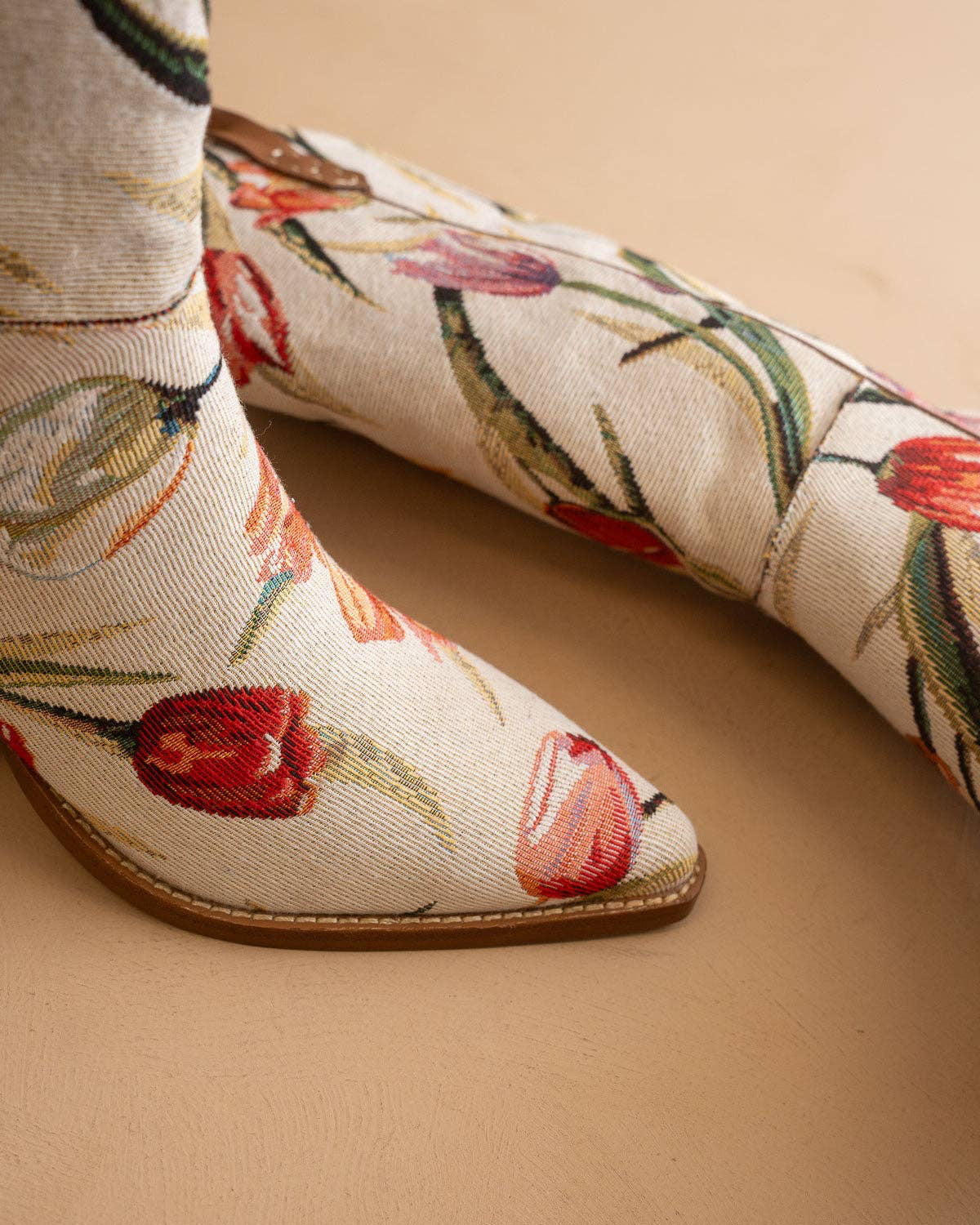 Floral embroidered shoes on a beige background
