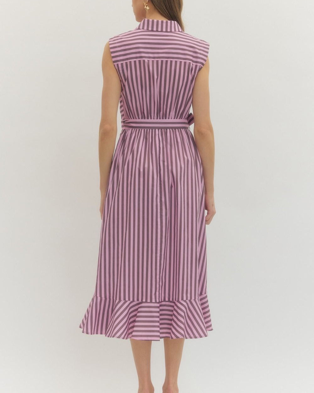 Woman wearing a sleeveless striped dress on a white background
