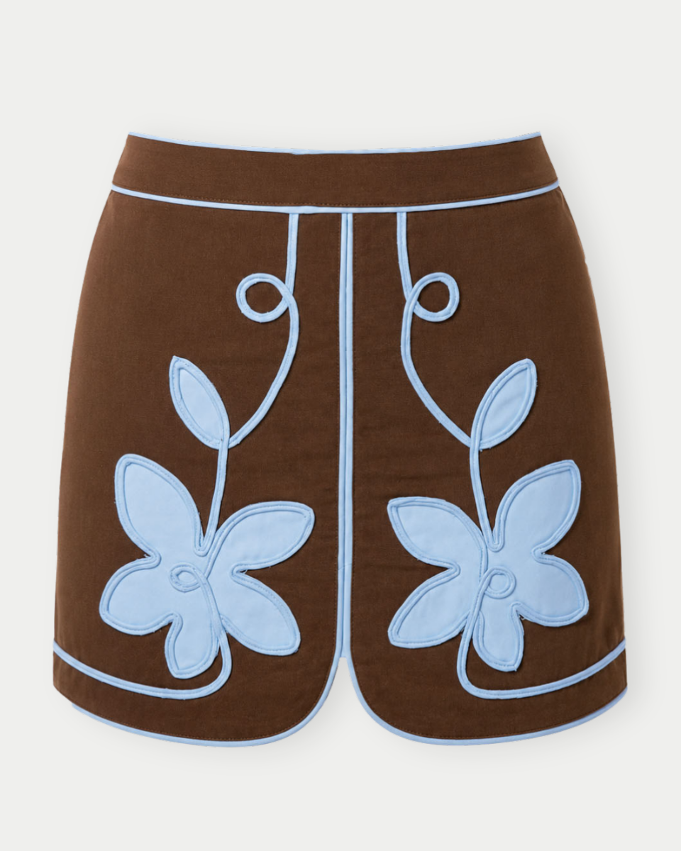 Brown shorts with blue floral designs on a white background