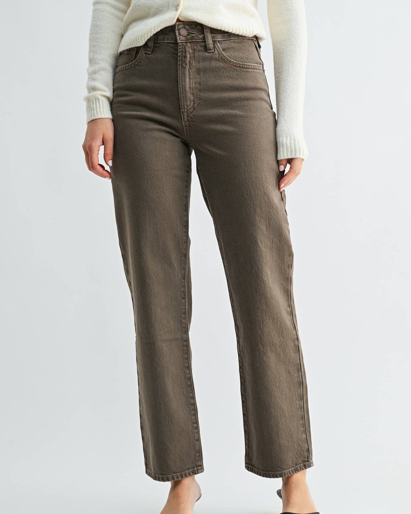 A model wearing a pair of vintage brown straight-leg jeans on a neutral background.