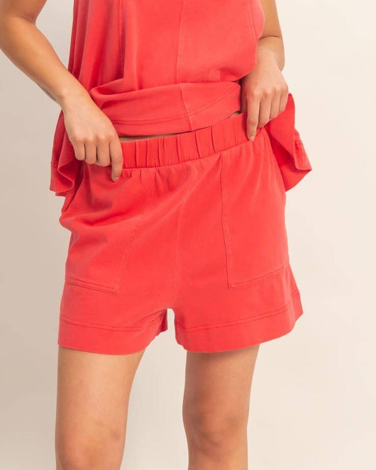 Woman wearing a red outfit against a plain background